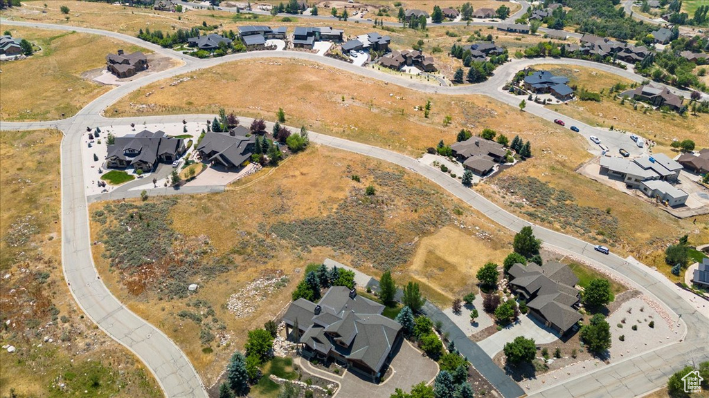 Aerial view of property and surrounding area featuring nearby suburban area
