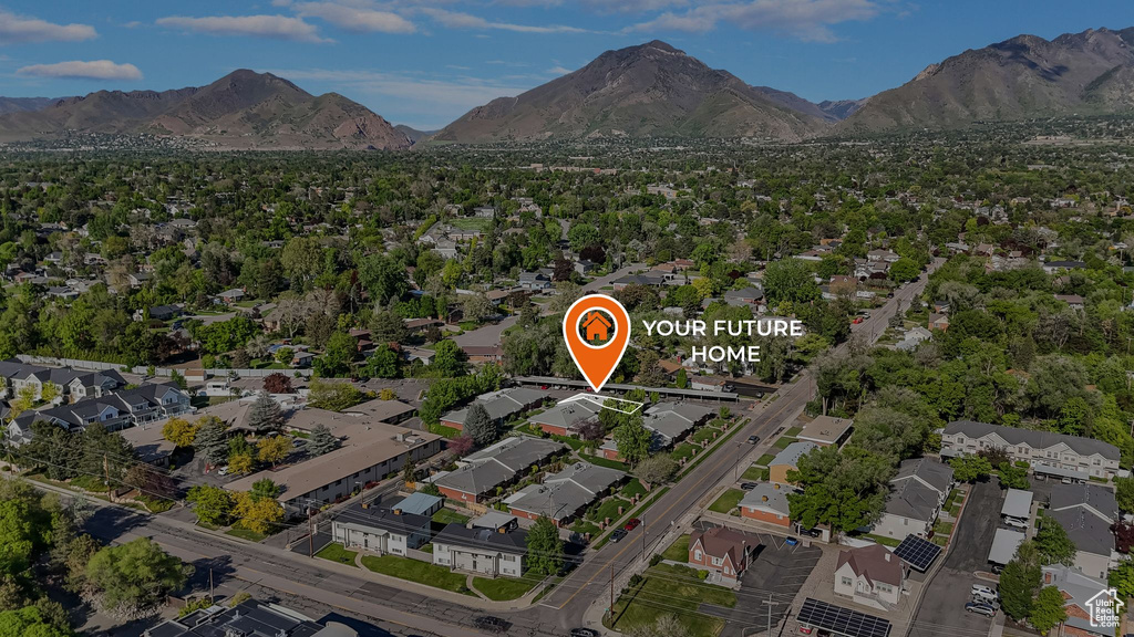 Aerial view of property's location with mountains and nearby suburban area
