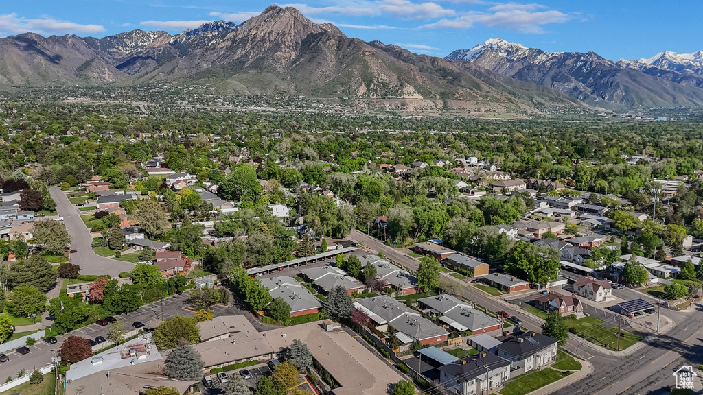 Aerial overview of property's location with a mountainous background and nearby suburban area