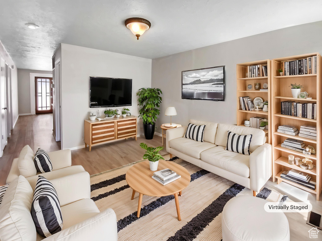 Living area featuring wood finished floors and baseboards