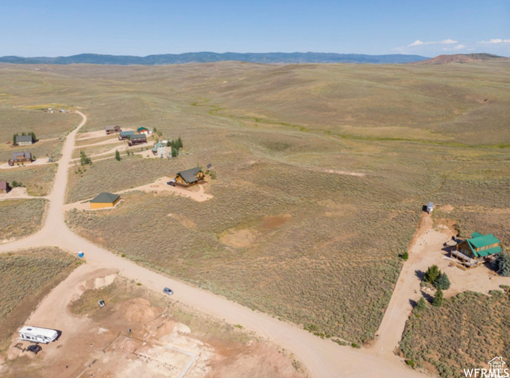 Aerial view of property's location featuring rural landscape and a mountain backdrop