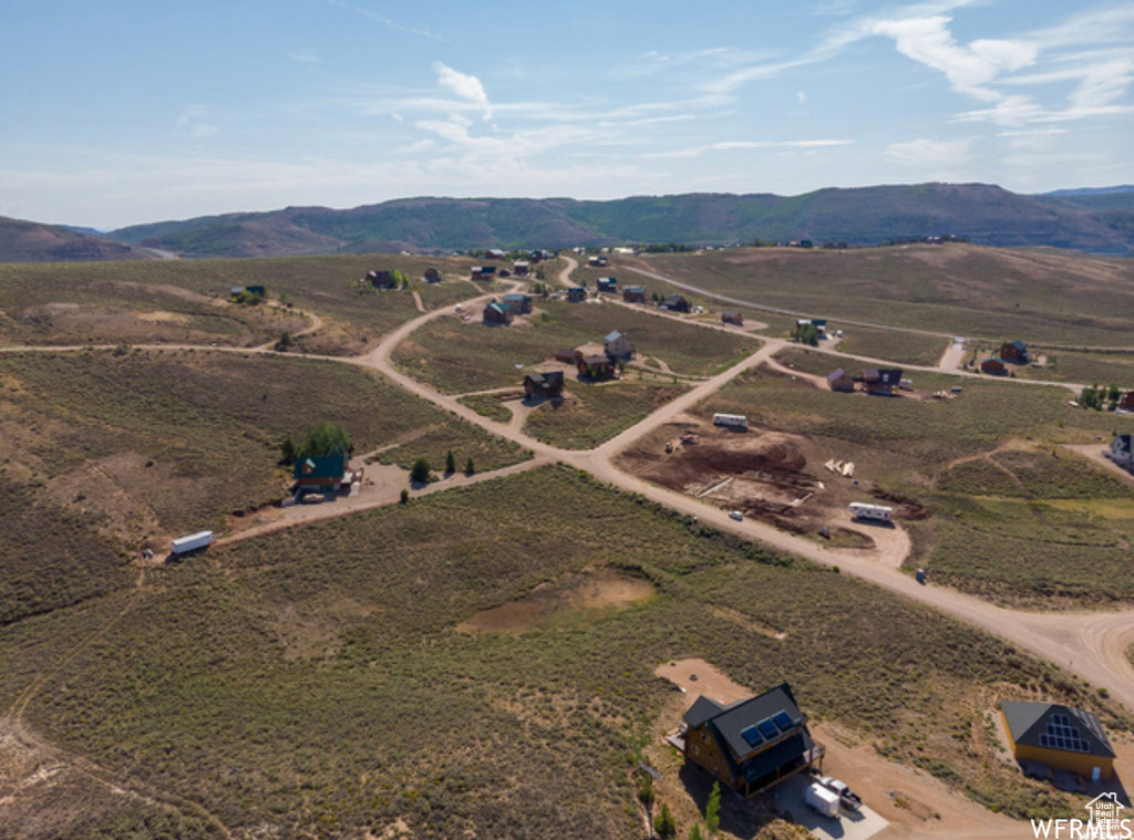 Aerial view of property and surrounding area with a mountain backdrop and rural landscape