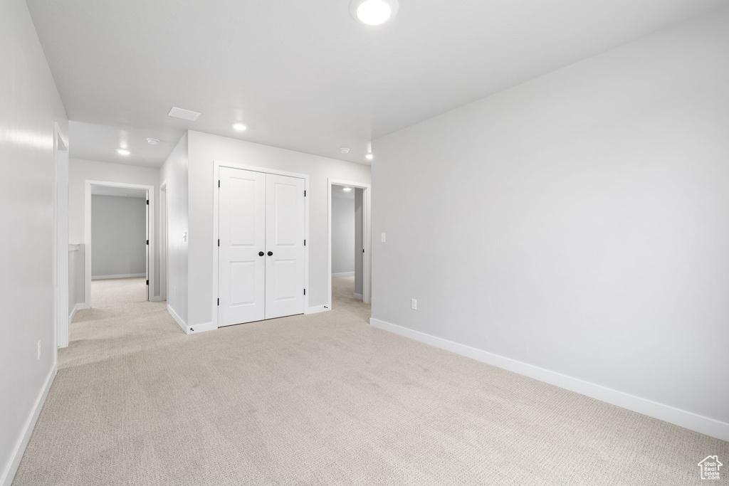 Unfurnished room with light colored carpet, recessed lighting, and baseboards