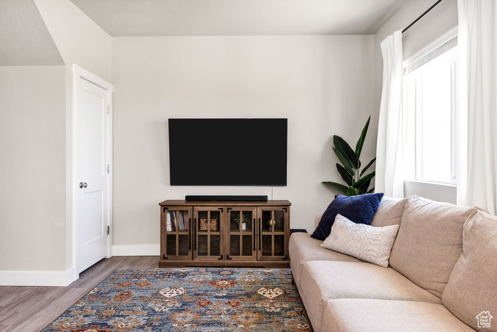 Living room with baseboards and wood finished floors