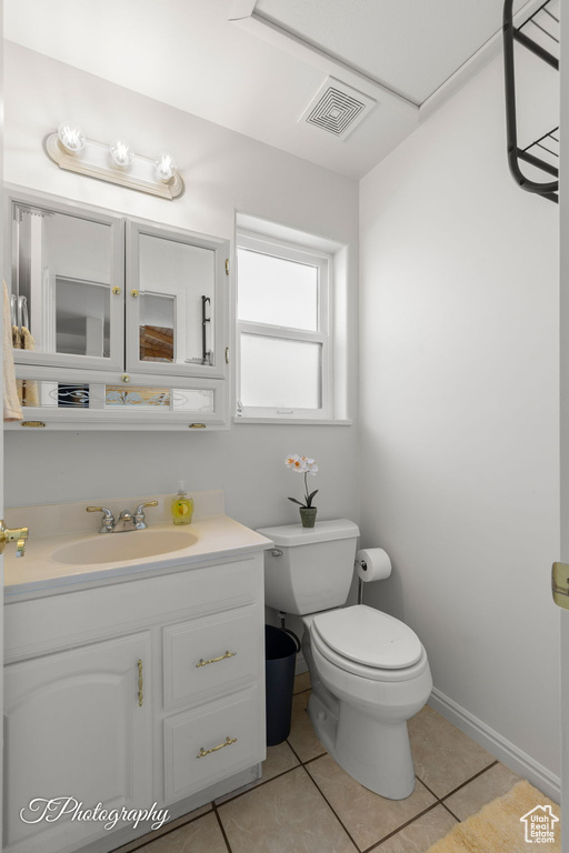 Bathroom with tile patterned floors, toilet, and vanity
