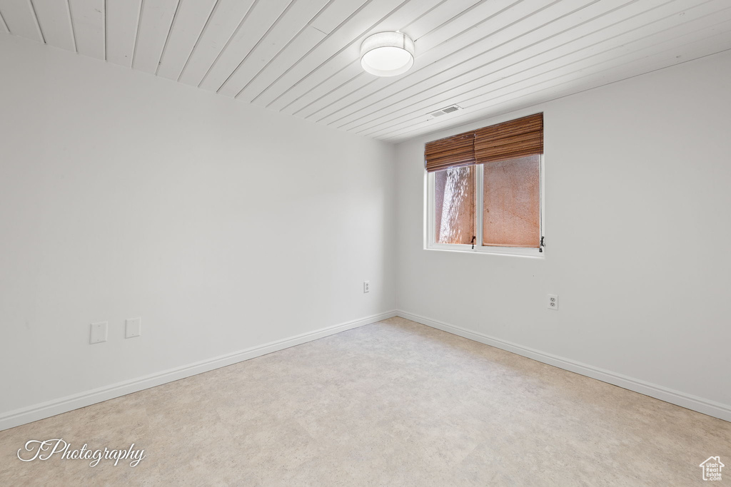Spare room with baseboards and carpet