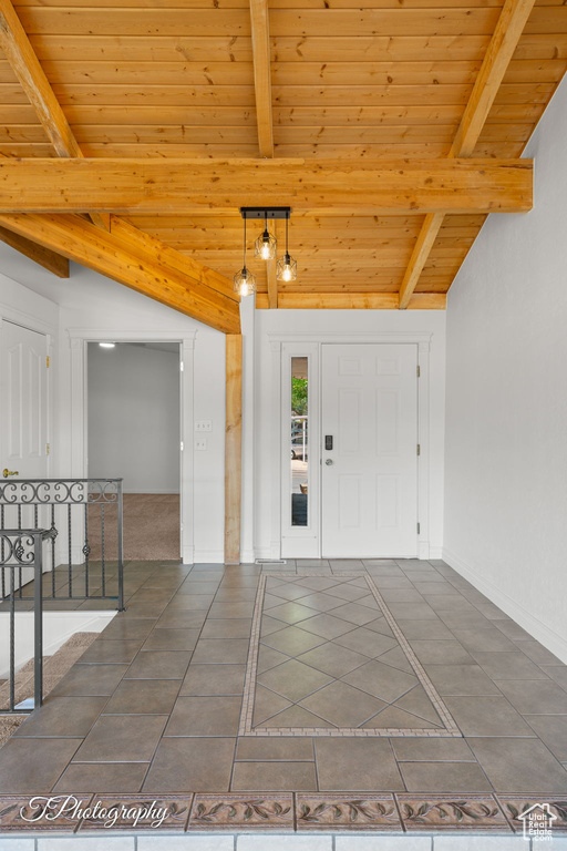 Tiled entrance foyer featuring wood ceiling and baseboards