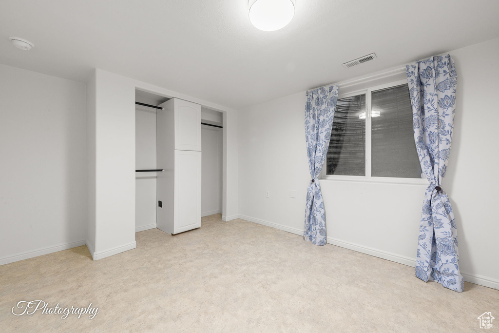 Unfurnished bedroom featuring baseboards and a closet
