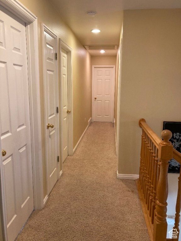 Corridor with light carpet, an upstairs landing, baseboards, and recessed lighting
