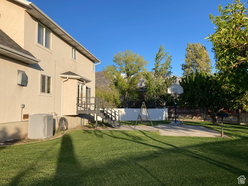 View of yard featuring central air condition unit and a patio