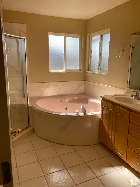 Full bath featuring a shower stall, tile patterned floors, vanity, and a whirlpool tub