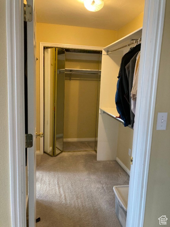 Walk in closet featuring carpet flooring