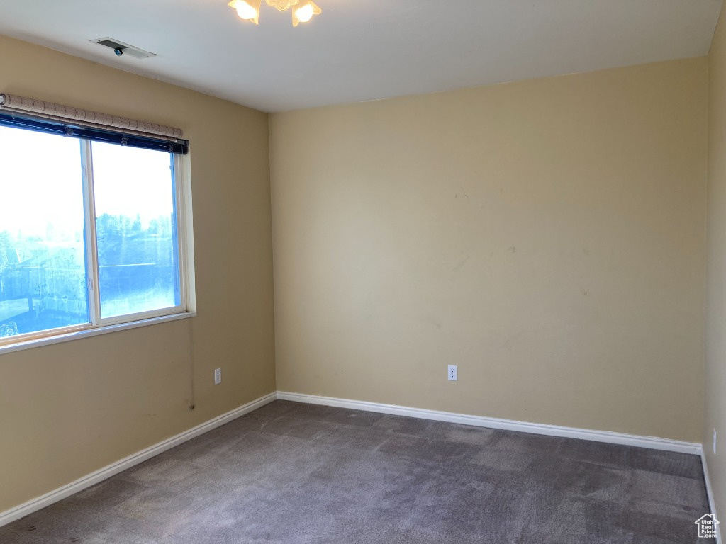 Carpeted empty room with baseboards