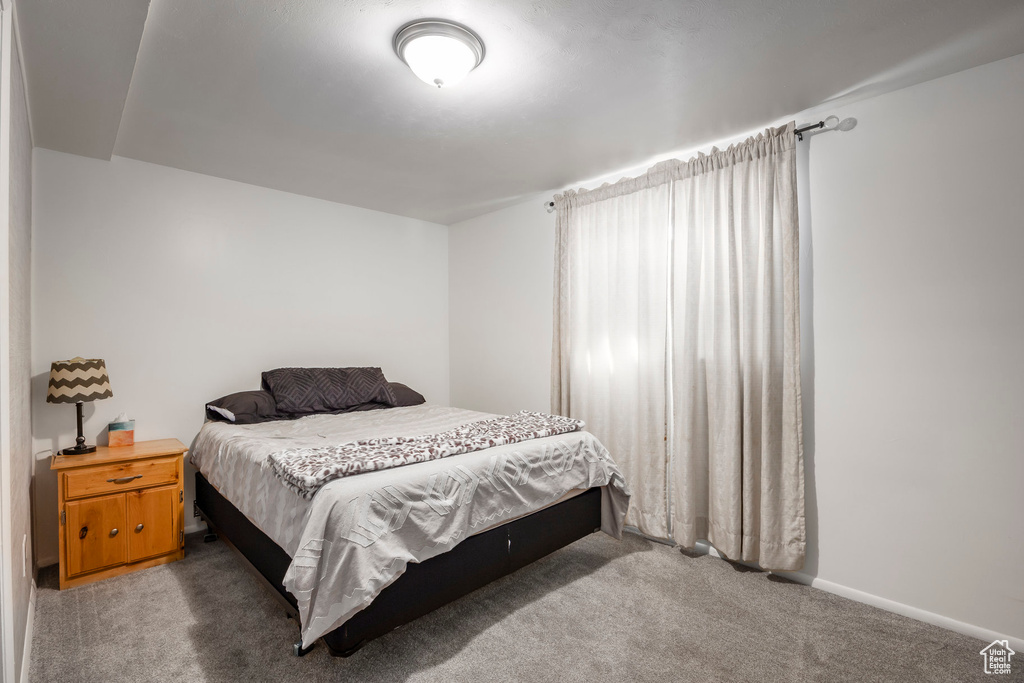 Carpeted bedroom featuring baseboards