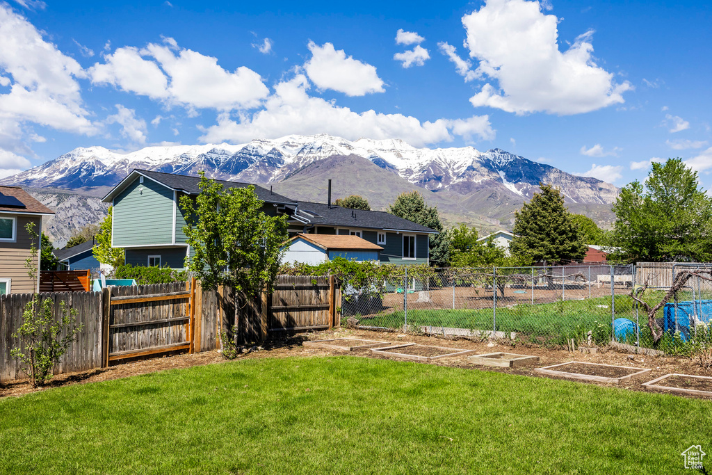 View of yard with a garden and a mountain view