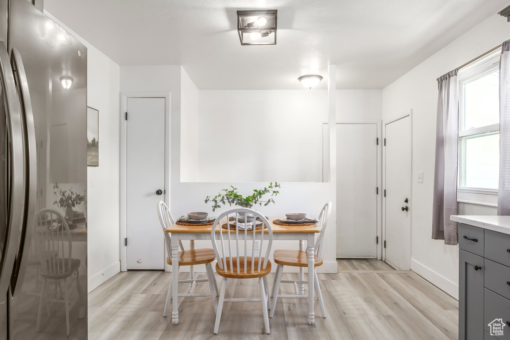 Dining room with light wood finished floors and baseboards