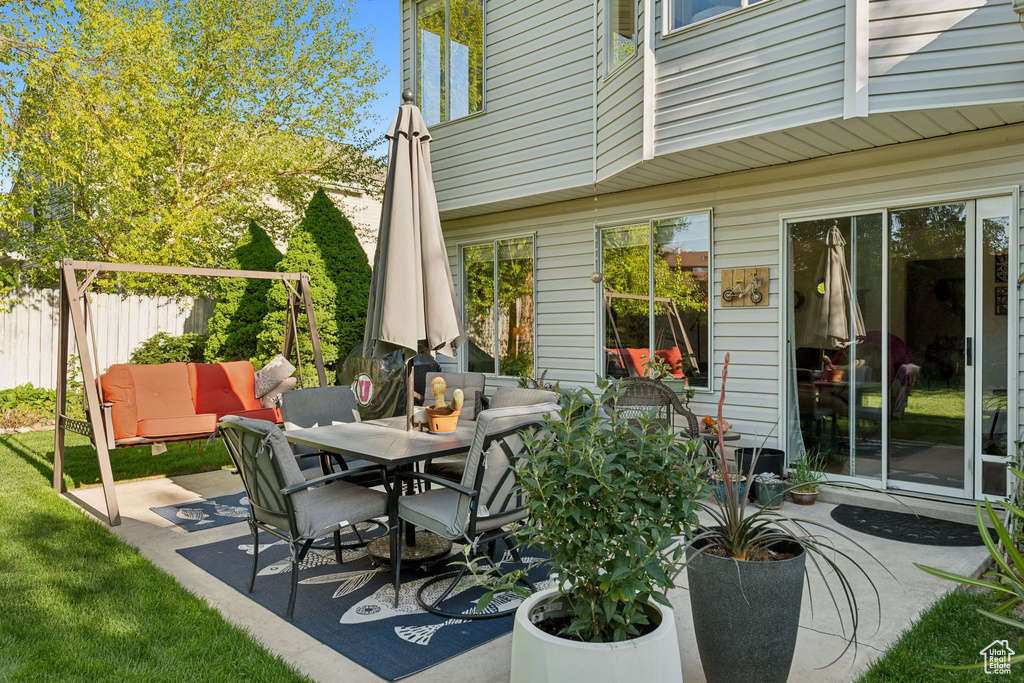 View of patio featuring fence and outdoor dining space