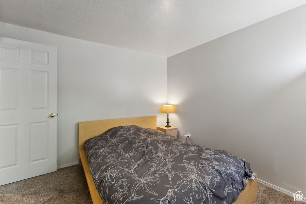 Carpeted bedroom with baseboards