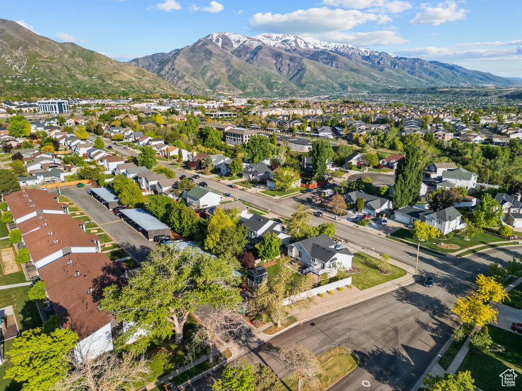 Aerial view of property's location with a mountain backdrop and nearby suburban area