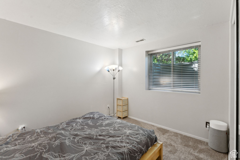 Carpeted bedroom featuring baseboards