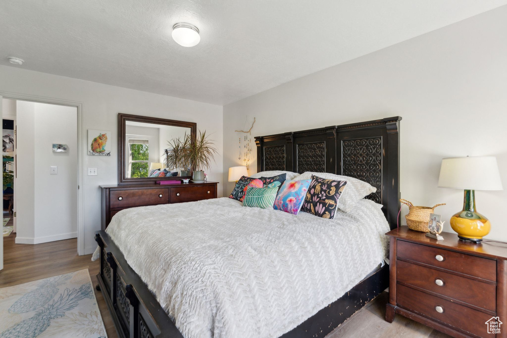 Bedroom featuring wood finished floors and baseboards