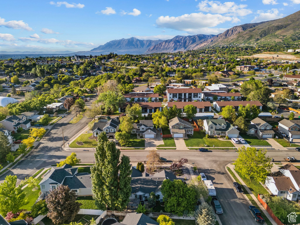 Aerial view of residential area featuring a mountainous background