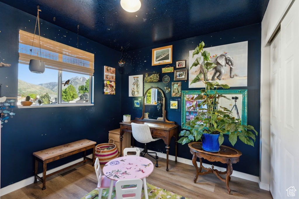 Home office with wood finished floors and baseboards