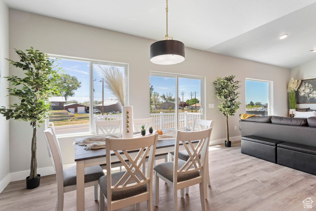 Dining space with light wood-type flooring, baseboards, plenty of natural light, and recessed lighting
