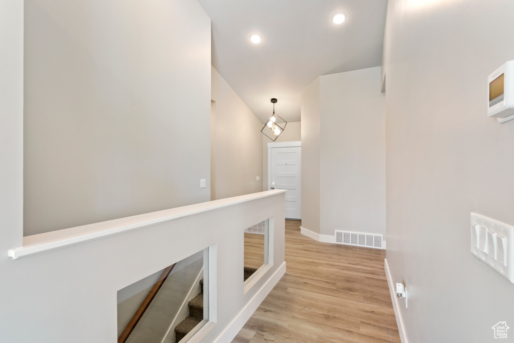 Corridor featuring baseboards, light wood-style floors, and recessed lighting