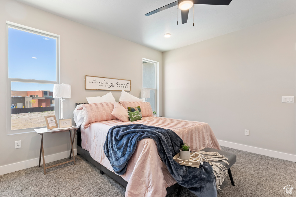 Bedroom featuring carpet flooring, baseboards, and a ceiling fan