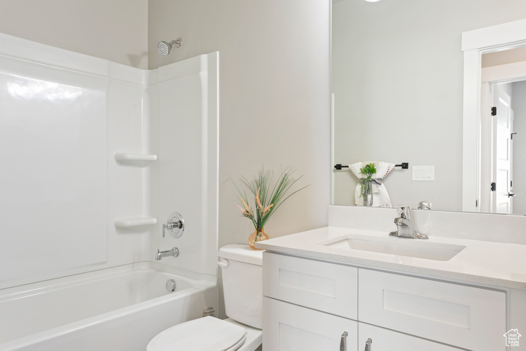 Bathroom with toilet, vanity, and bathing tub / shower combination