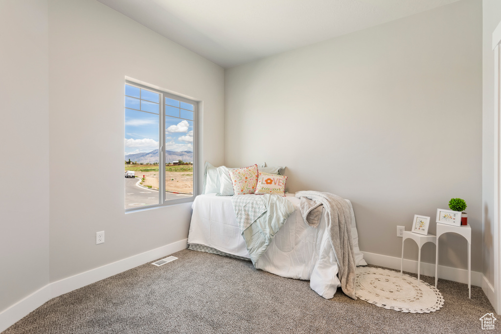 Carpeted bedroom with baseboards