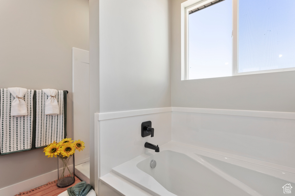 Full bathroom featuring a bath