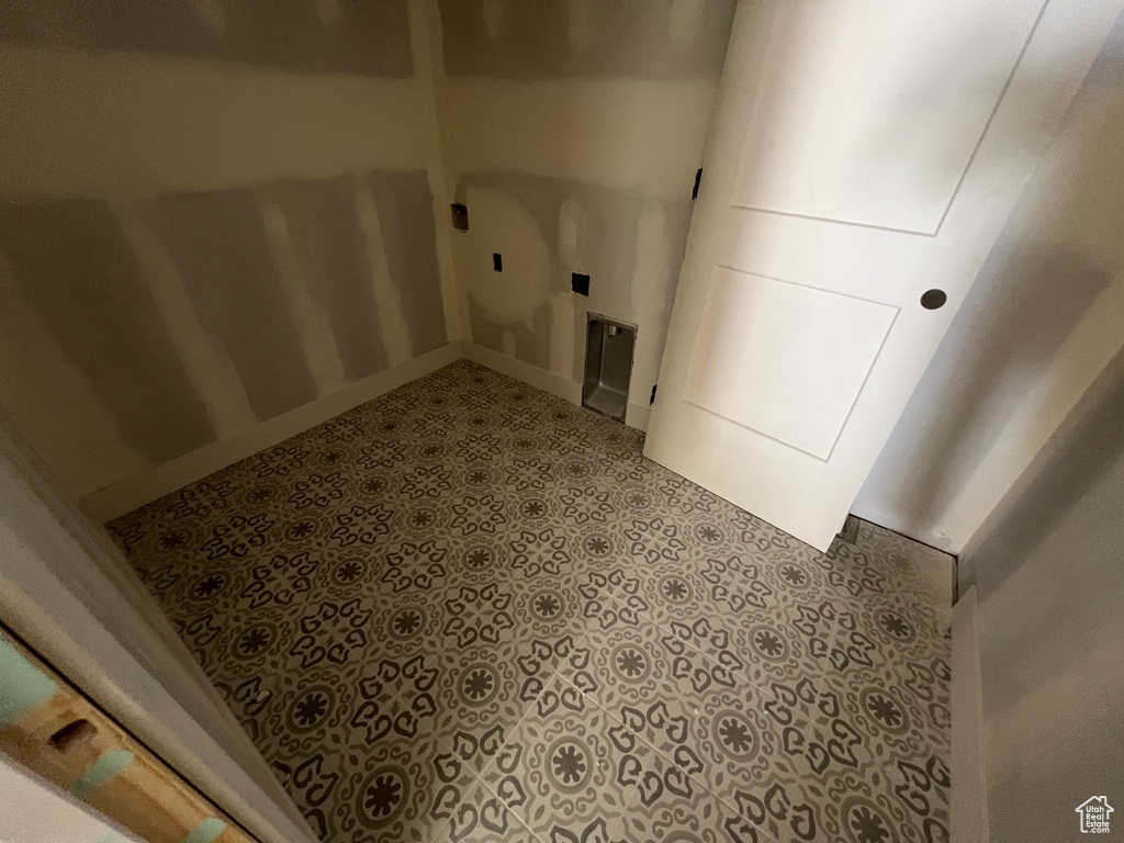 Laundry area featuring tile patterned floors