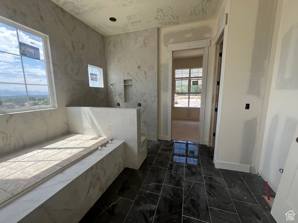 Full bathroom with marble finish floors and a walk in shower