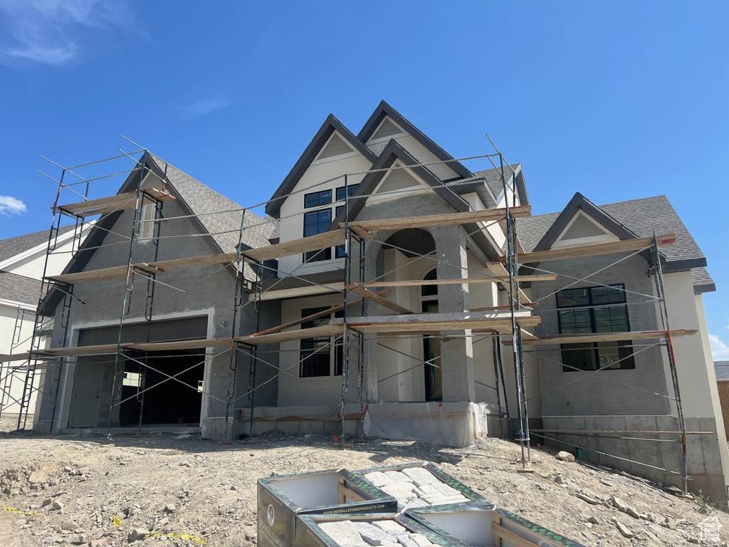 Back of house with a shingled roof