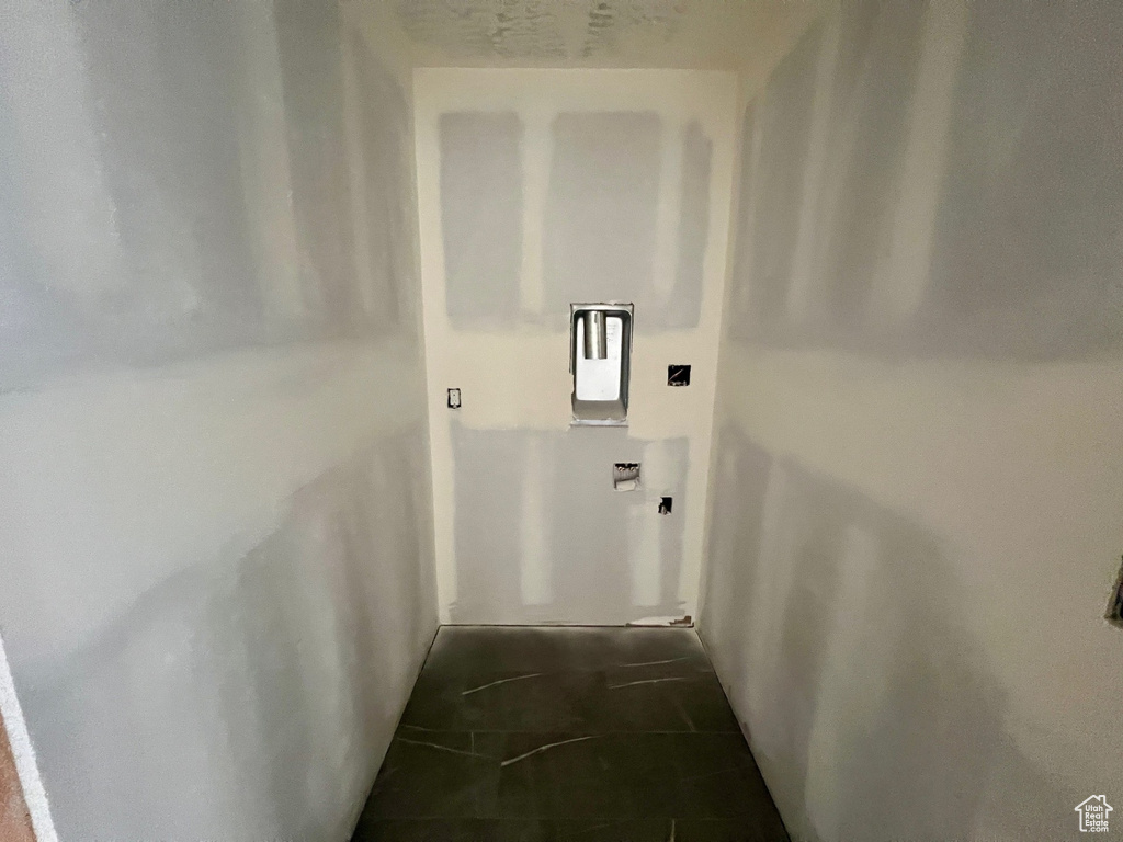 Hall with dark tile patterned floors