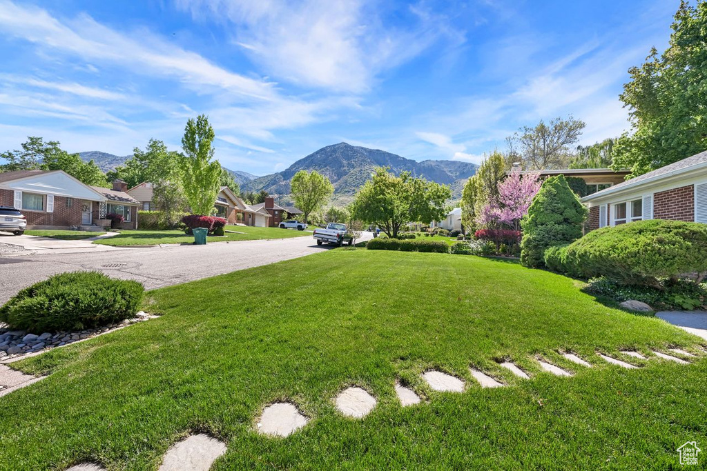 View of grassy yard featuring a mountain view and a residential view