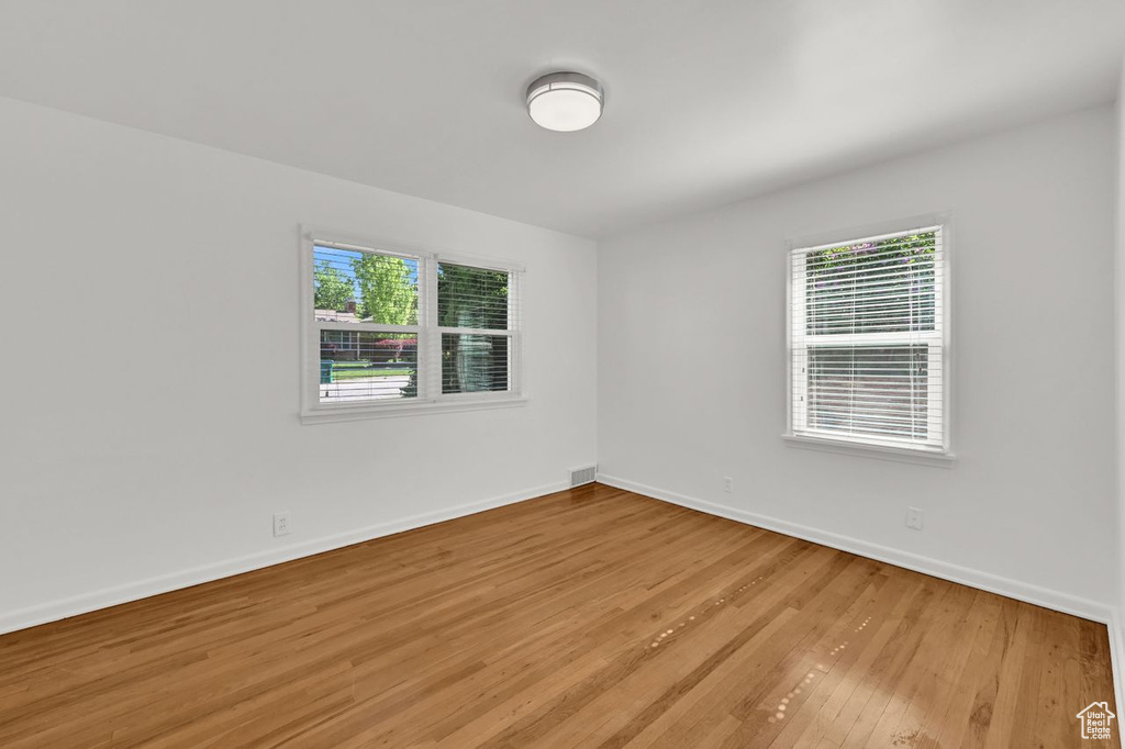 Unfurnished room featuring baseboards and light wood finished floors