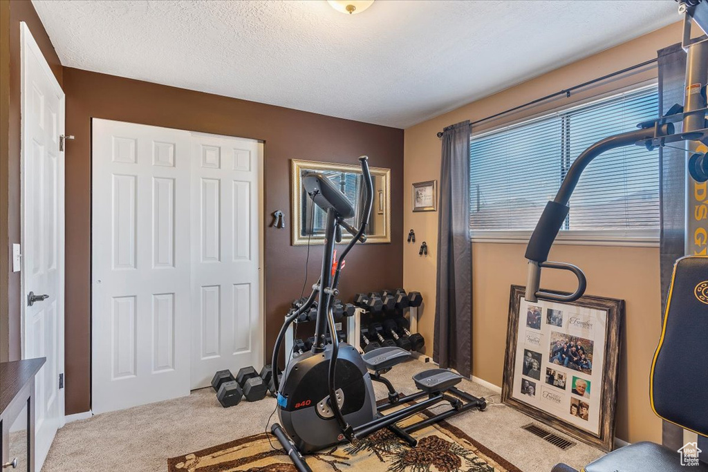 Workout room featuring carpet flooring