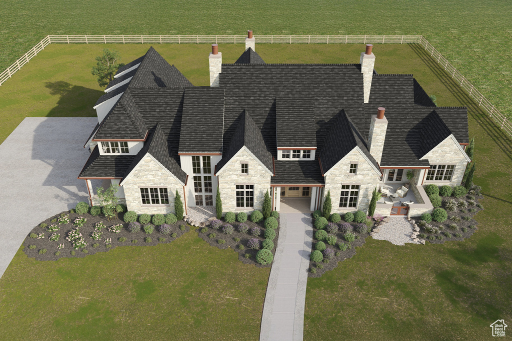 View of front of property with stone siding, a chimney, and a front yard