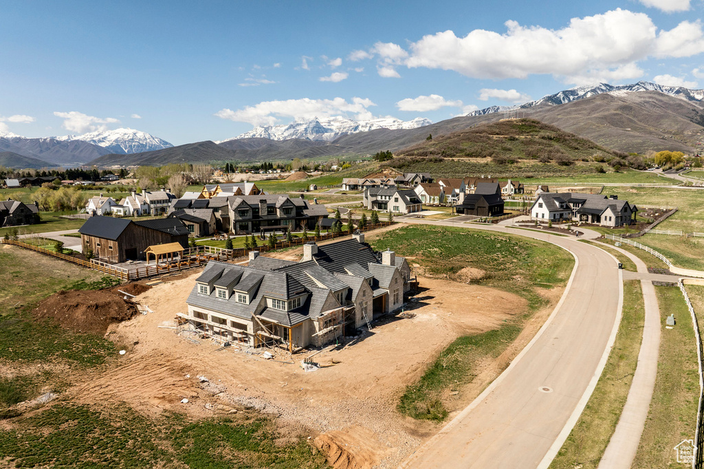 Aerial view of residential area featuring a mountainous background