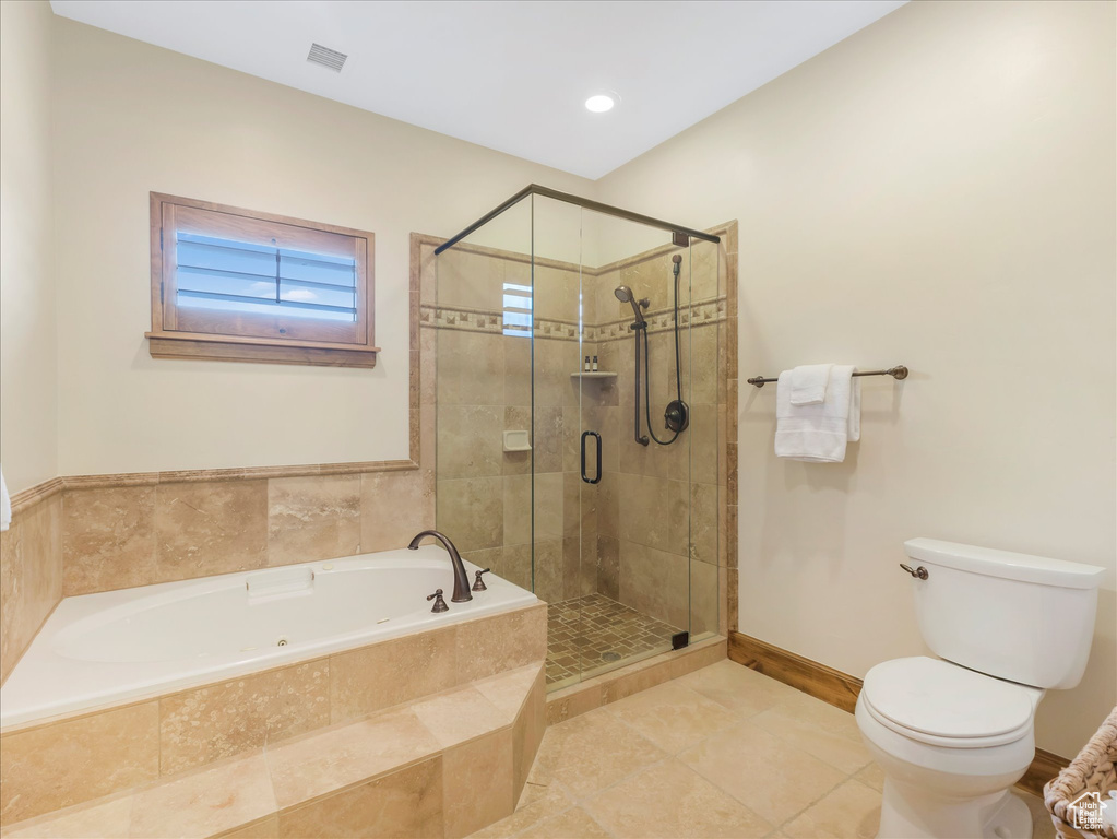 Bathroom featuring a garden tub, toilet, a stall shower, tile patterned floors, and baseboards