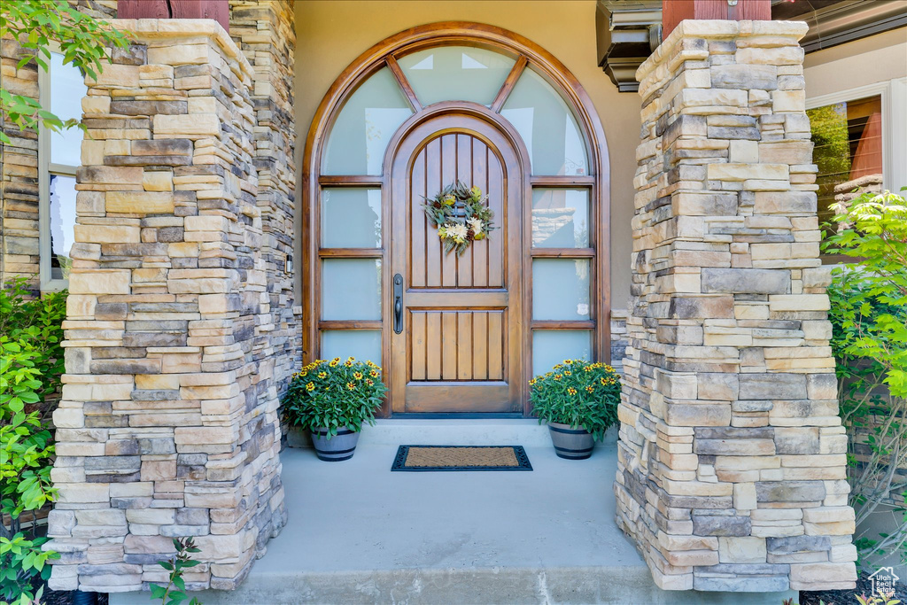 Entrance to property featuring stone siding