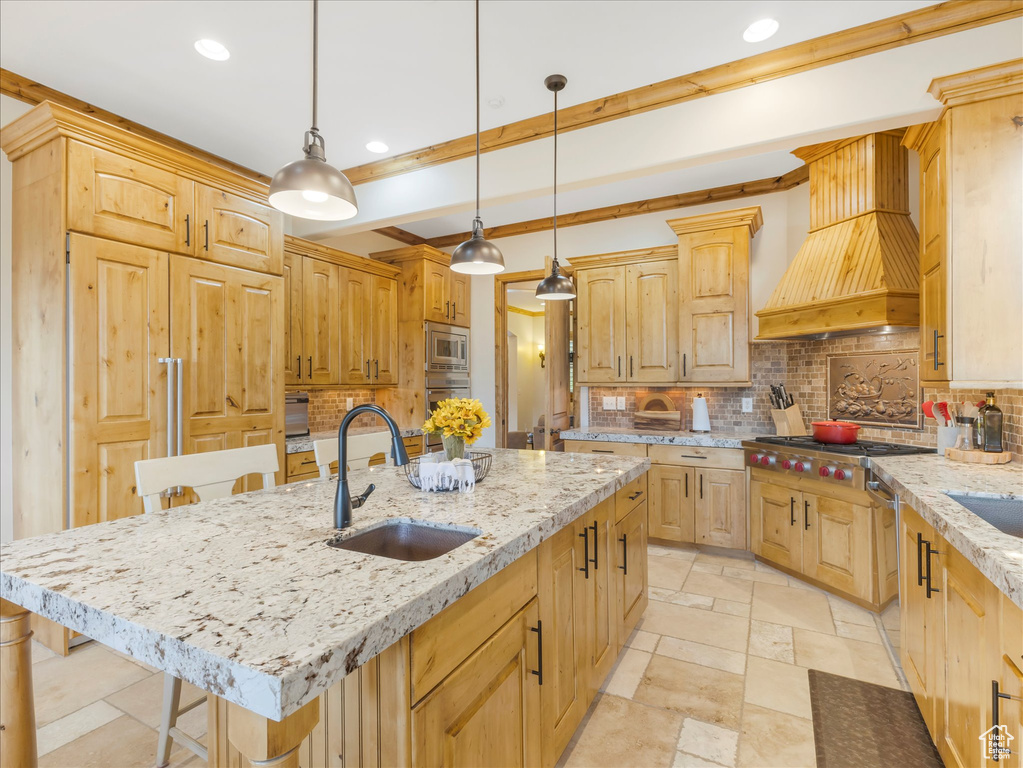 Kitchen featuring a sink, custom exhaust hood, stainless steel appliances, light brown cabinets, and recessed lighting