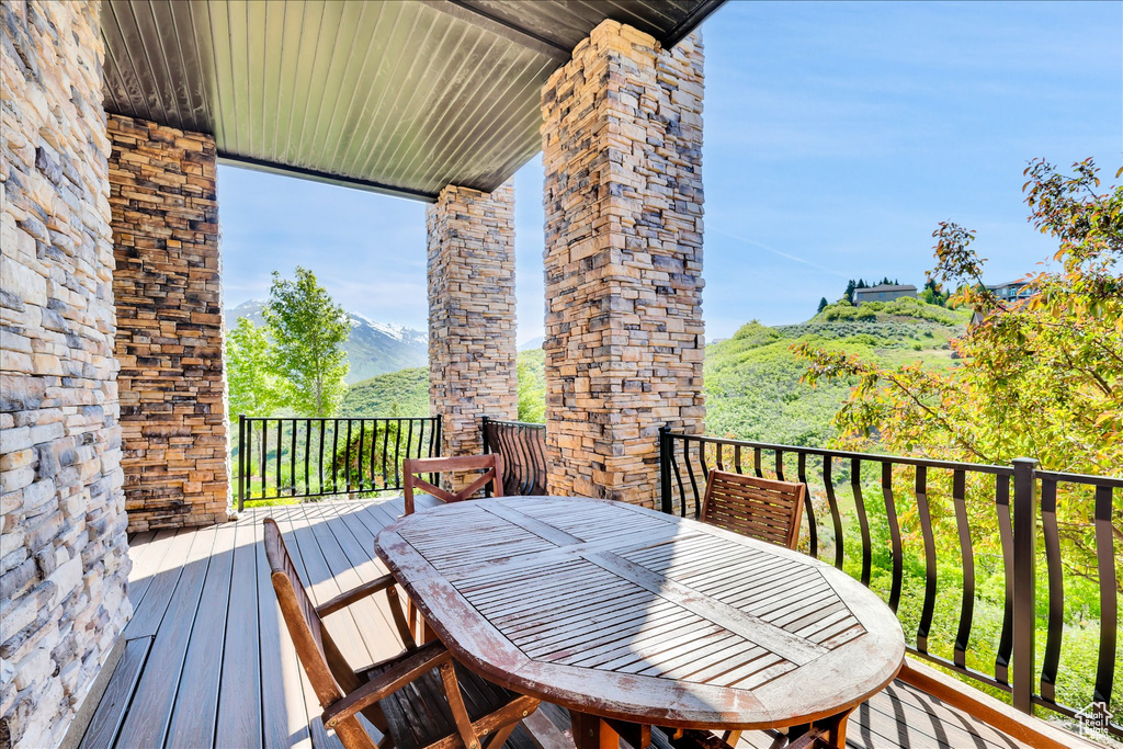 Wooden terrace featuring outdoor dining area