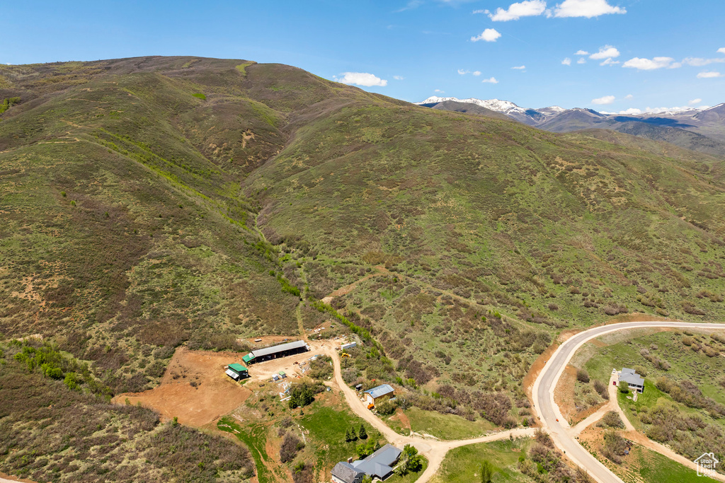 Aerial view of property and surrounding area featuring mountains