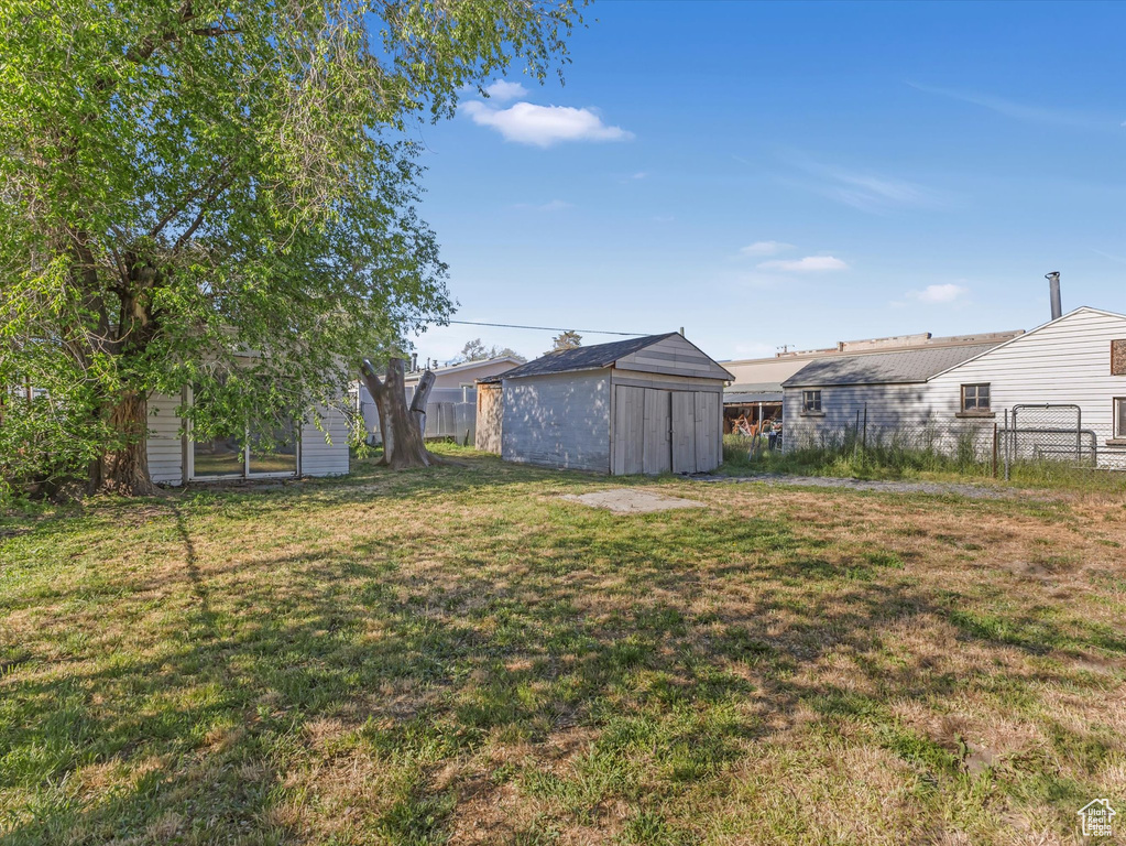 View of yard with a storage shed and an outdoor structure