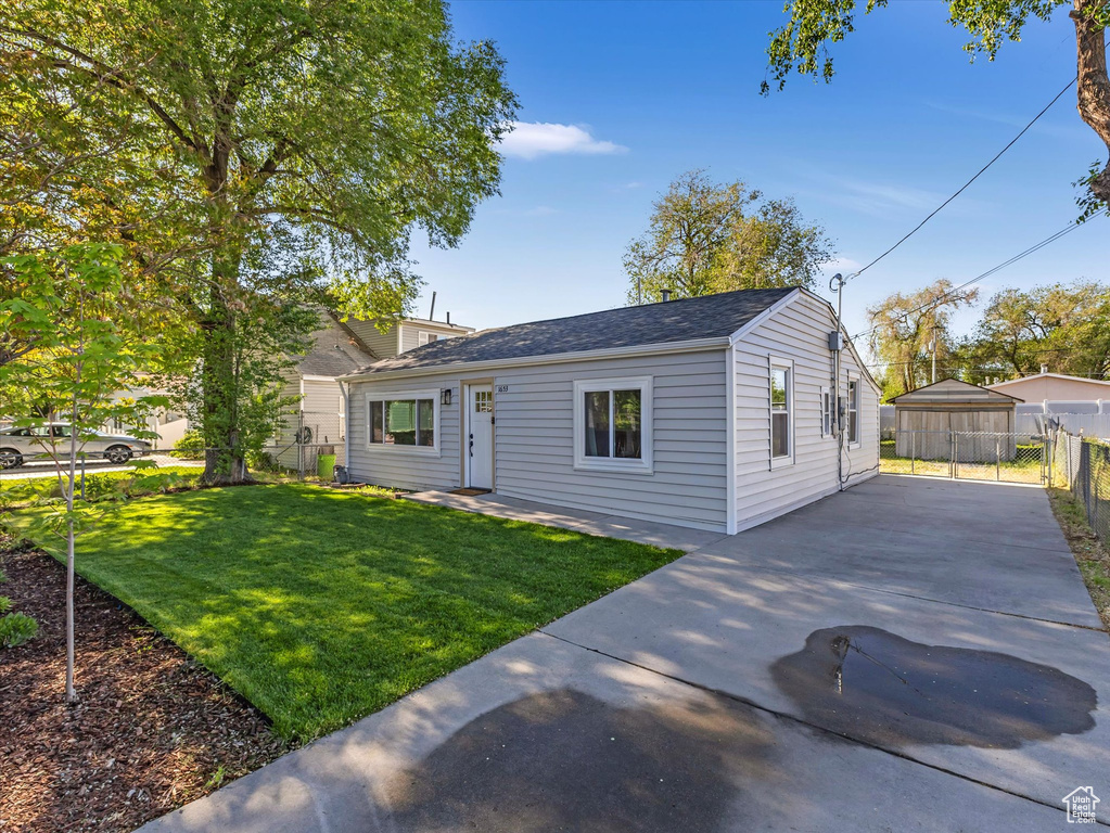View of front facade featuring concrete driveway and roof with shingles