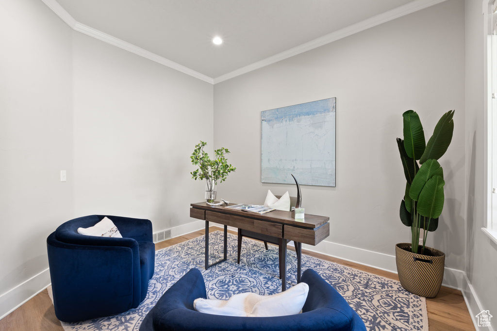 Office space featuring crown molding, baseboards, wood finished floors, and recessed lighting